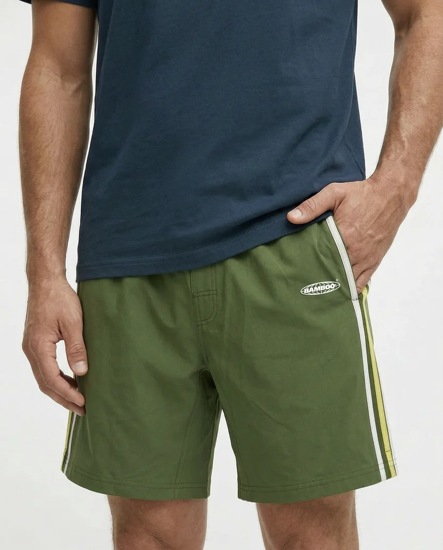 Close view of Retro Moss Boundless Shorts showing the fabric, pockets and side stripe