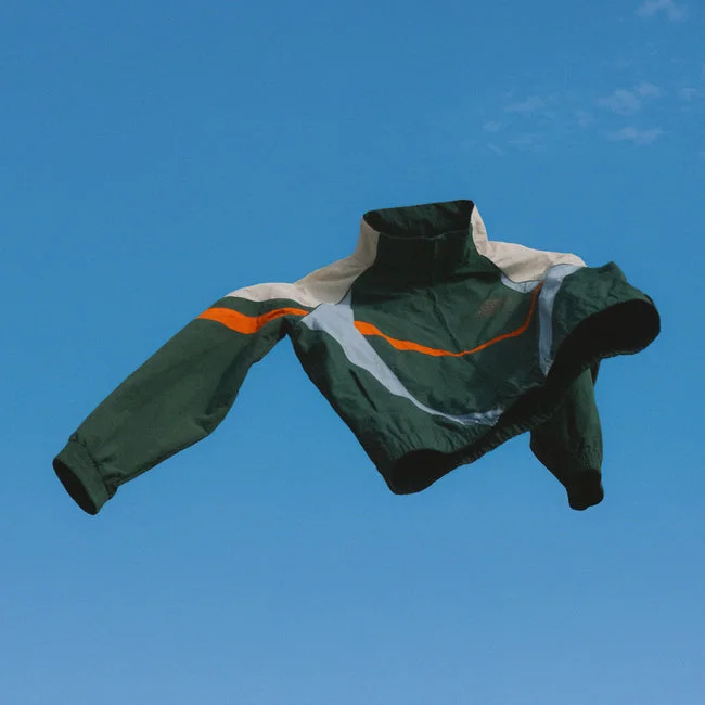 Bamboo Avenue jacket suspended against a bright blue sky